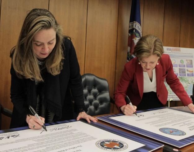 In March 2019, senior government executives Margaret Weichert (left) and Lisa Hershman (right) sign an agreement for enterprise digital learning reform